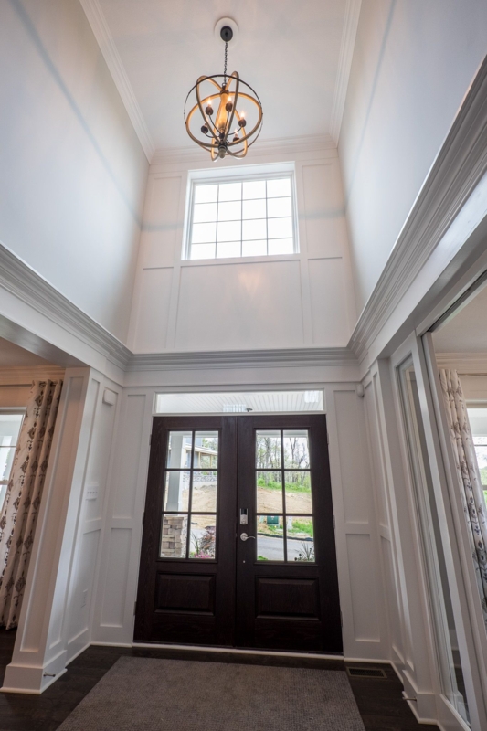 Bright Two-Story Foyer with Orbital Light Fixture