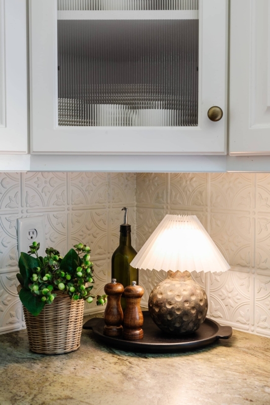 Charming Kitchen Corner with Terracotta Lamp and Greenery