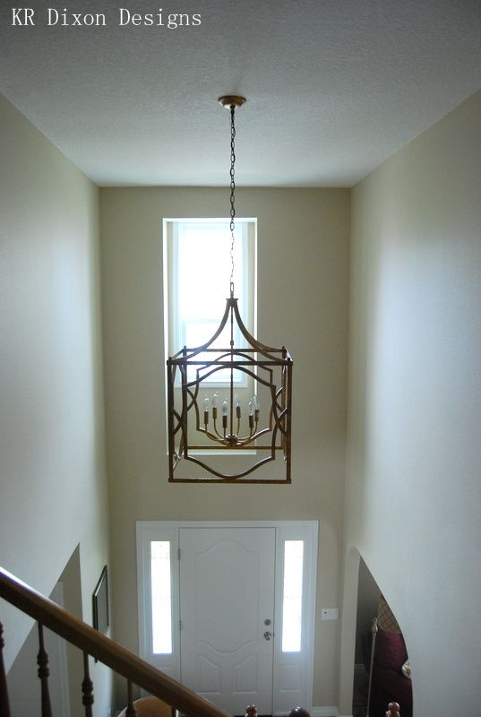 Charming Two-Story Foyer with Geometric Chandelier
