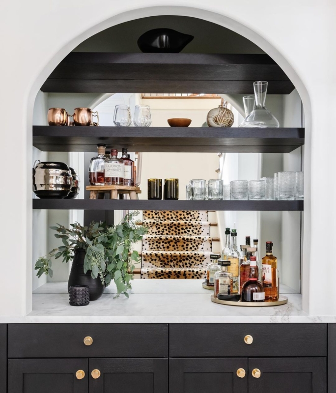 Elegant Arched Bar with Black Cabinets and Shelves