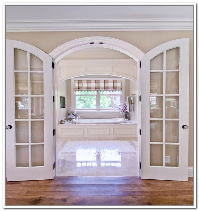 Elegant Arched French Doors Leading to Bright Bathroom