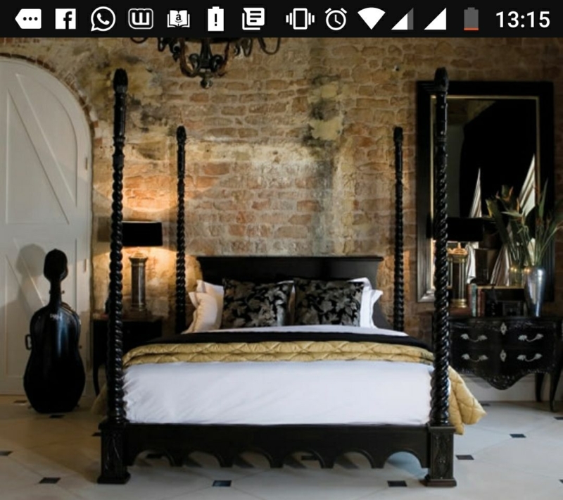 Elegant Black Four-Poster Bed with Exposed Brick Wall