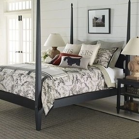 Elegant Black Four-Poster Bed with Floral Bedding