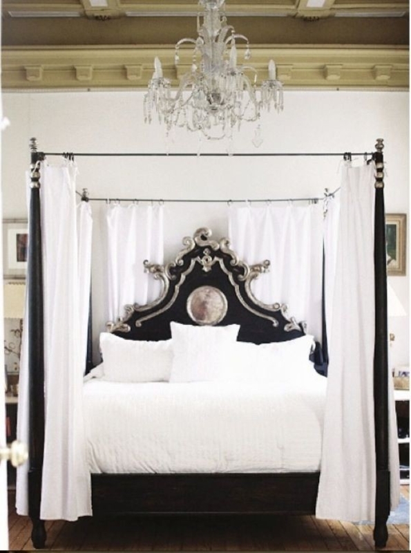 Elegant Black Four Poster Bed with White Drapes