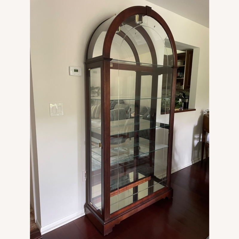 Elegant Howard Miller Arched Cherry Glass Curio Cabinet