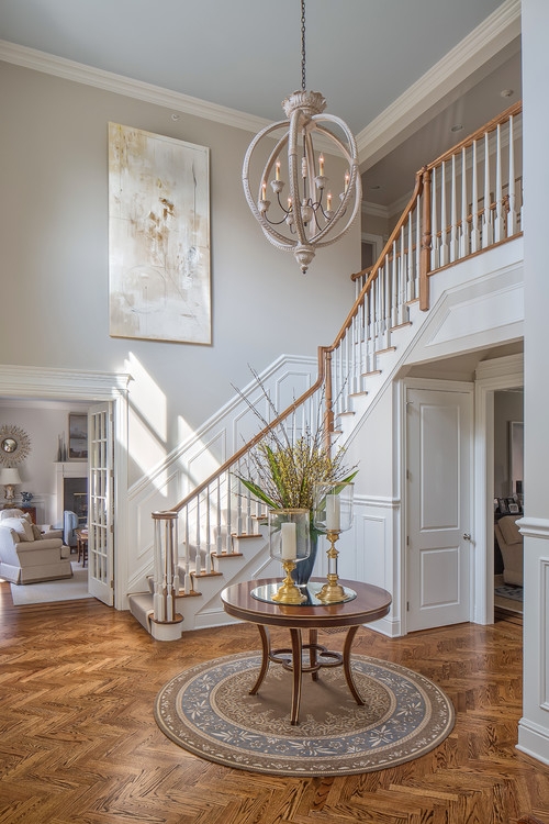 Elegant Two-Story Foyer with Classic Chandelier and Staircase