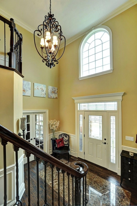 Elegant Two-Story Foyer with Iron Chandelier