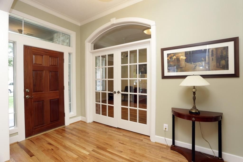 Elegant Wooden Entrance with Arched French Doors