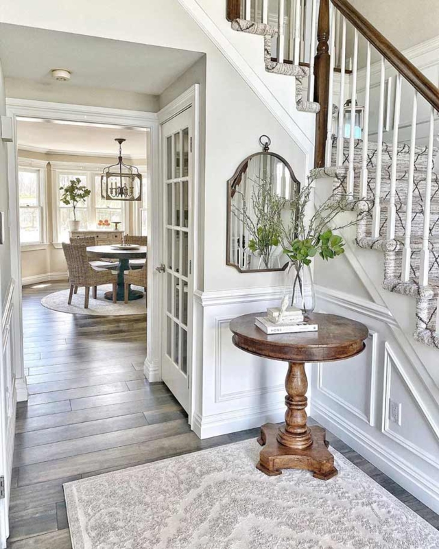 Farmhouse Entryway with Rustic Wooden Table and Mirror