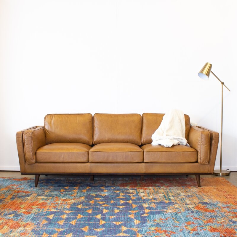 Modern Camel Leather Sofa with Vibrant Geometric Rug