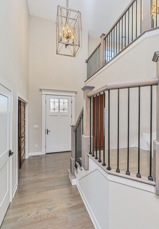 Modern Two-Story Foyer with Geometric Chandelier Lighting