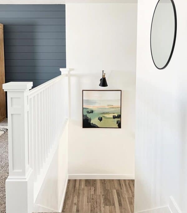 Bright Modern Stairway with Wall Sconce and Art