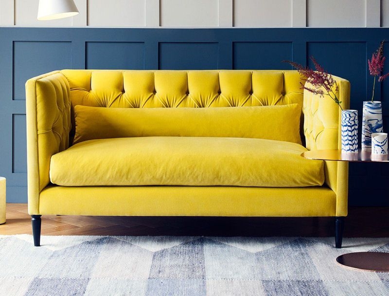 Bright Yellow Velvet Sofa with Modern Blue Wall
