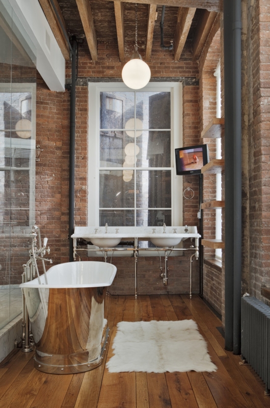 Chic Industrial Bathroom with Metal Tub and Exposed Brick
