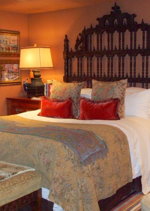 Cozy Spanish Colonial Bedroom with Ornate Headboard