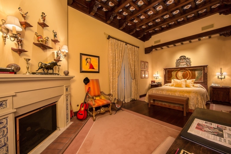 Cozy Spanish-Style Bedroom with Rustic Wooden Beams