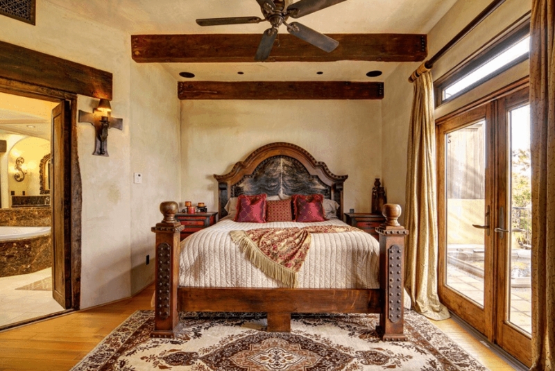 Cozy Spanish-Style Primary Bedroom with Rustic Wood Beams