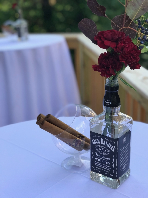 Elegant Cigar Party Table with Whiskey Bottle Vase
