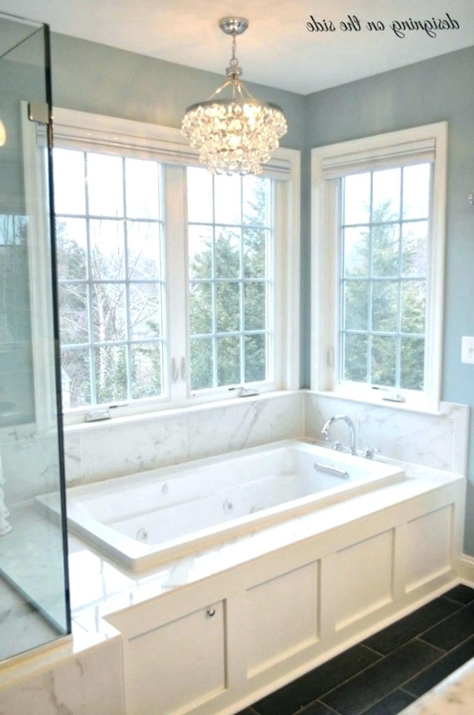 Elegant Crystal Chandelier Above Marble Bathtub