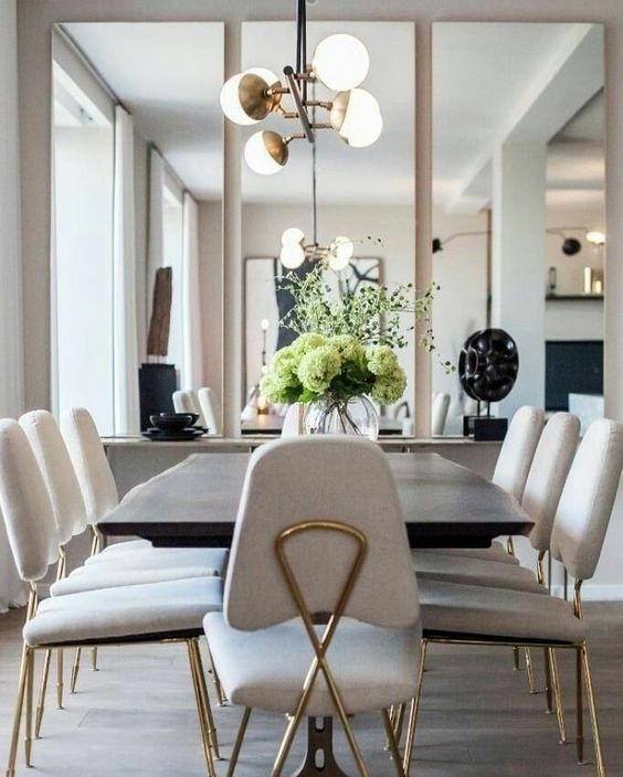 Elegant Dining Room with Mirrors and Modern Lighting