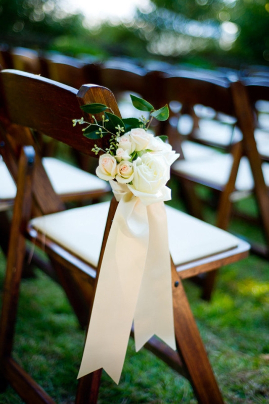 Elegant Wedding Chairs Decorated with Satin Sash and Flowers