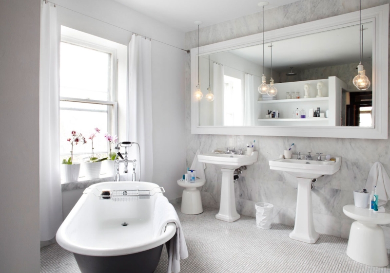 Elegant White Bathroom with Freestanding Bathtub and Pedestal Sinks