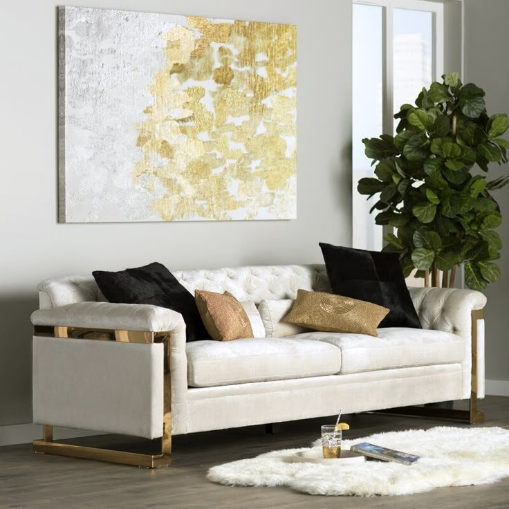 Elegant White Sofa with Gold Accents and Decor