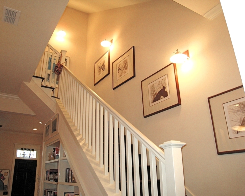Elegant White Stair Railing with Wall Sconces