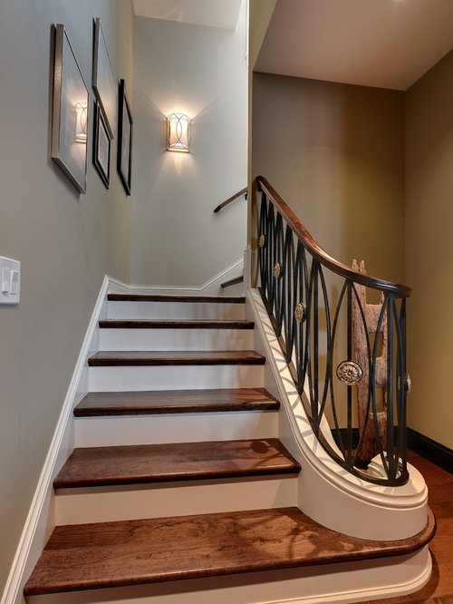 Elegant Wooden Staircase with Ornate Iron Railing Design