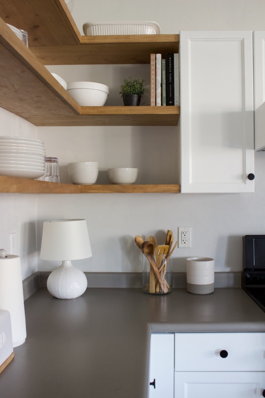 Minimalist Kitchen with White Table Lamp and Wooden Shelves