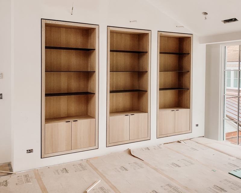 Modern Built-In White Oak Bookcases with Black Shelves