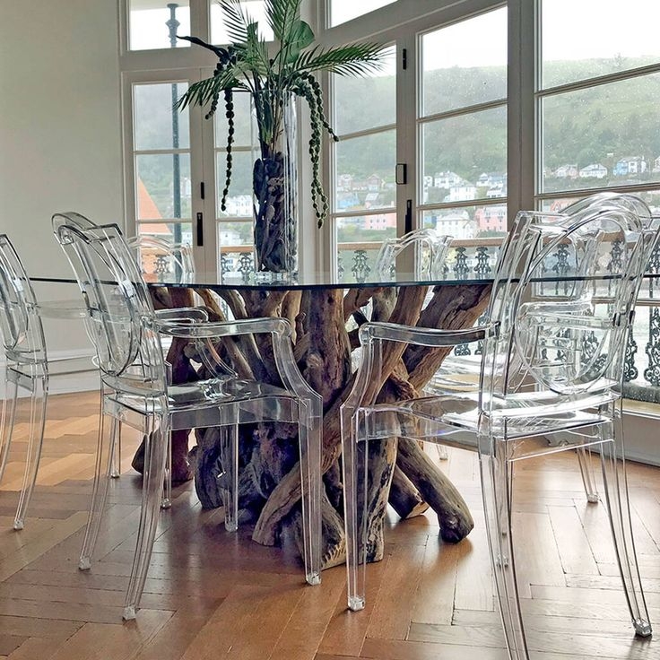 Modern Glass Table with Driftwood Base and Transparent Chairs
