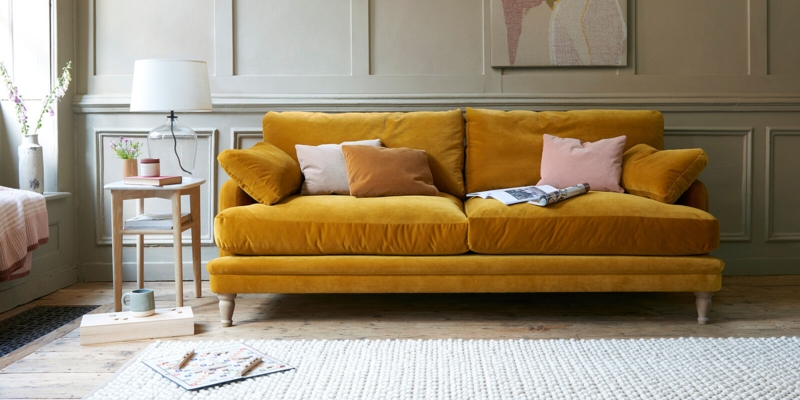 Mustard Yellow Velvet Sofa with Pastel Accent Pillows
