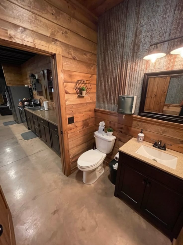 Rustic Shed Bathroom with Wood Paneling and Tile Floors