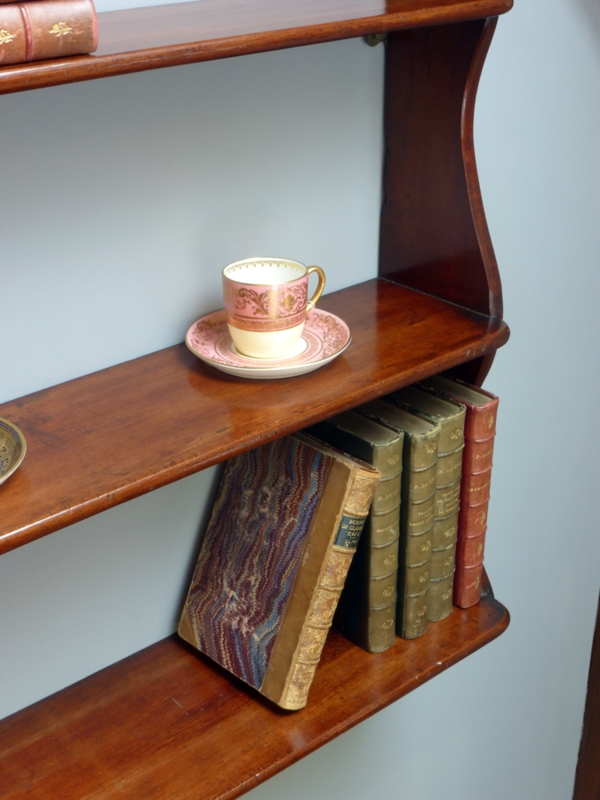Vintage Wooden Shelves with Antique Books and Teacup
