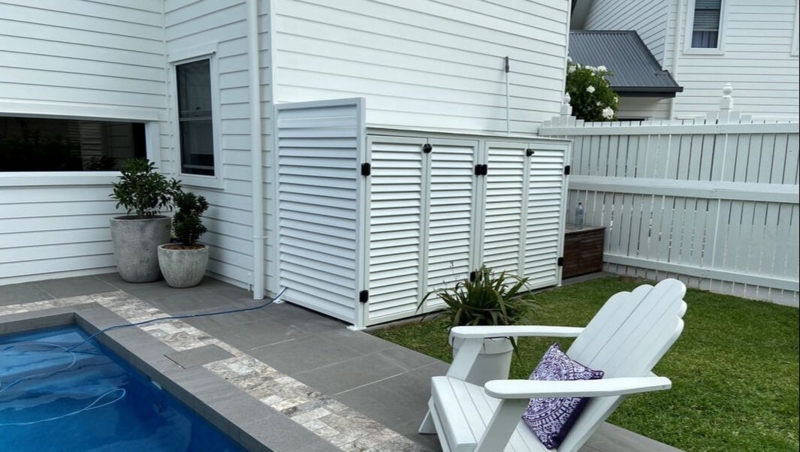 White Pool Pump Enclosure Enhances Backyard Privacy