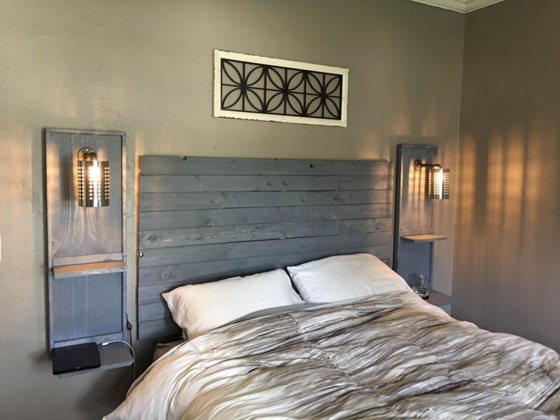 Cottage Bedroom with Floating Nightstands and Wooden Headboard