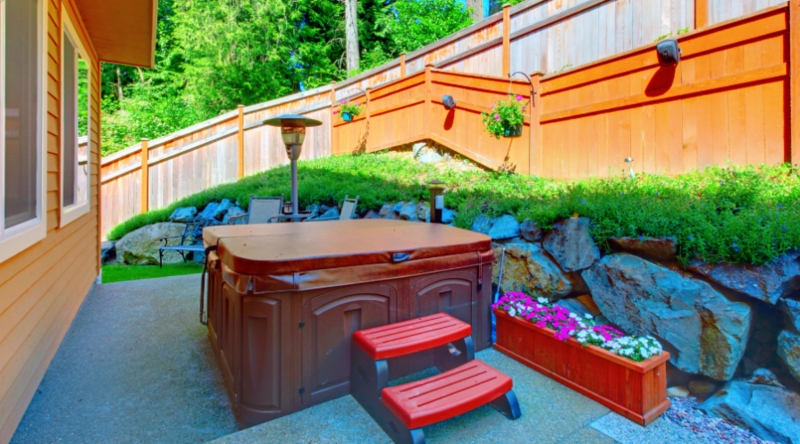 Cozy Outdoor Hot Tub Area with Natural Rock Accent