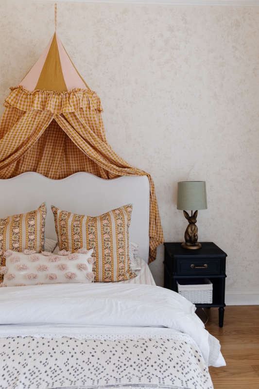 Cozy Scalloped Bed with Rustic Canopy and Vintage Touches