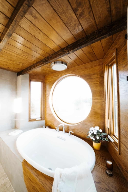 Cozy Wooden Tiny House Bathroom with Round Window