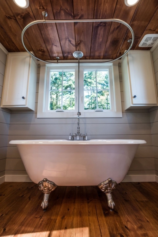 Elegant Clawfoot Tub with Wood Ceiling and Natural Light