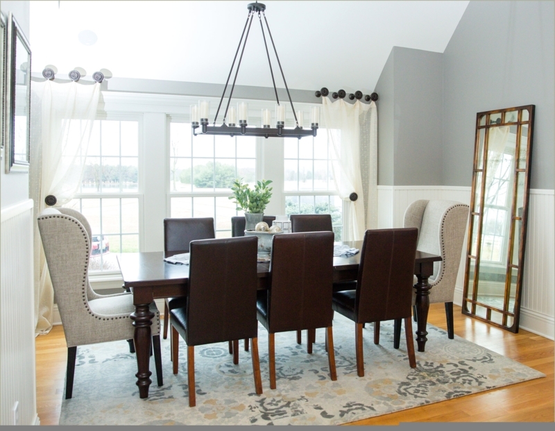 Elegant Dining Room with Captain Chairs and Large Windows