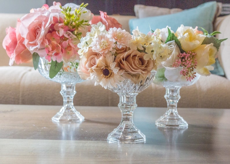 Elegant Glass Pedestal Vases with Soft Floral Arrangements