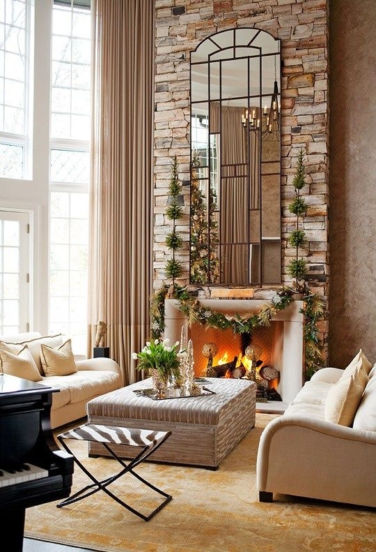 Elegant Large Mirror Reflecting Chandelier Over Fireplace