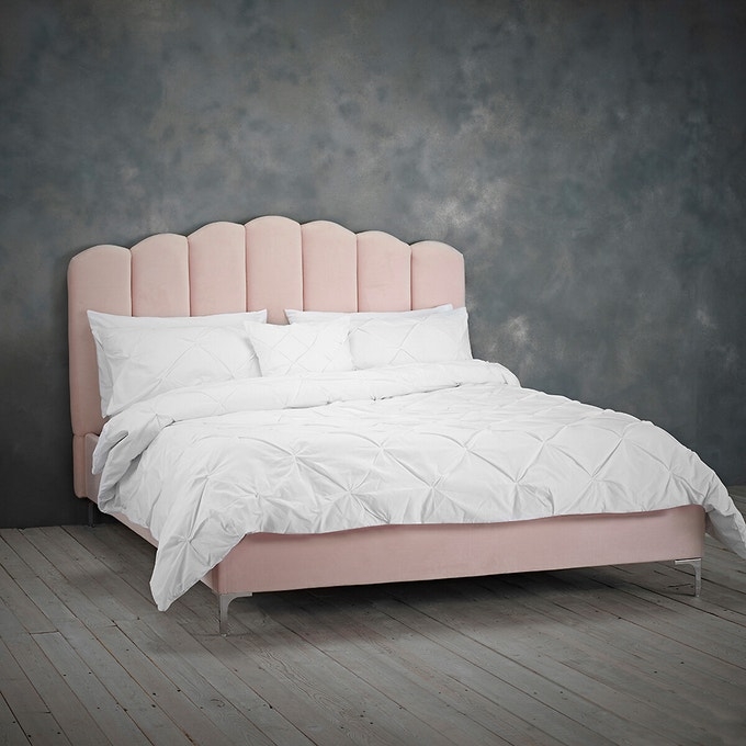 Elegant Pink Upholstered Bed with Crisp White Bedding