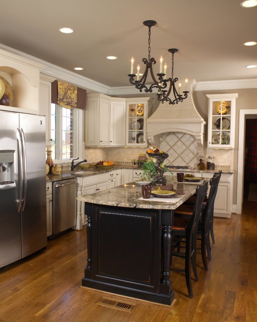 Elegant White Kitchen with Black Island and Chandeliers