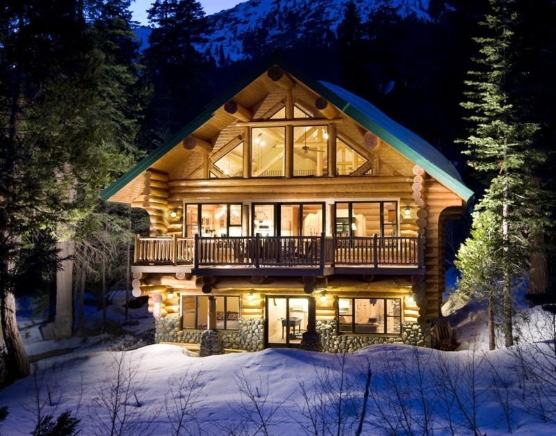 Illuminated Rustic Log Cabin in Snowy Forest