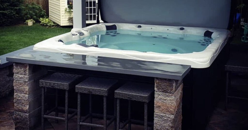 Modern Backyard Hot Tub with Built-In Bar Seating