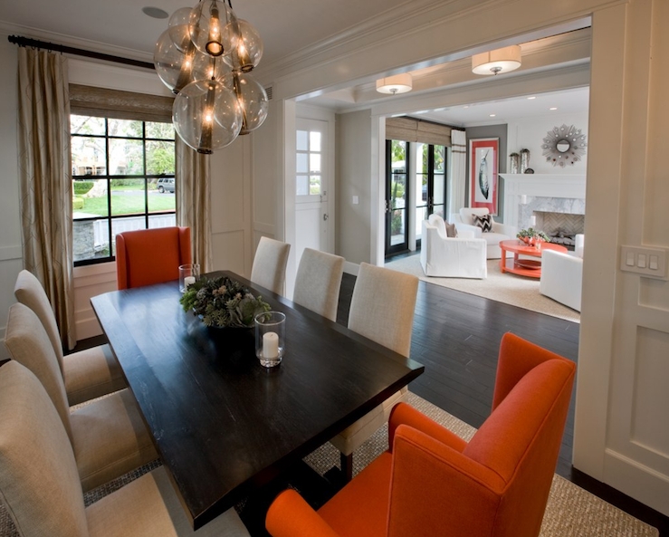 Modern Dining Room with Bold Orange Captain Chairs