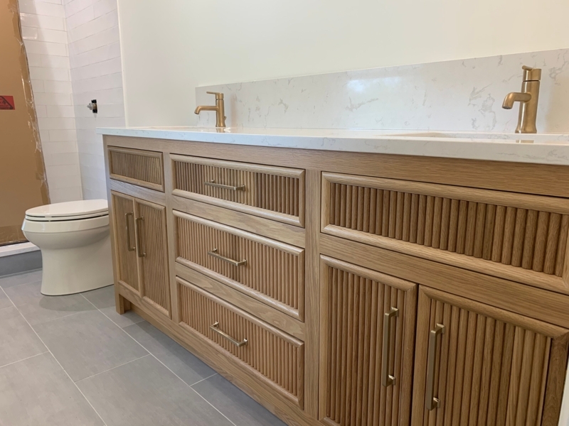 Modern Fluted Wood Vanity with Brass Fixtures